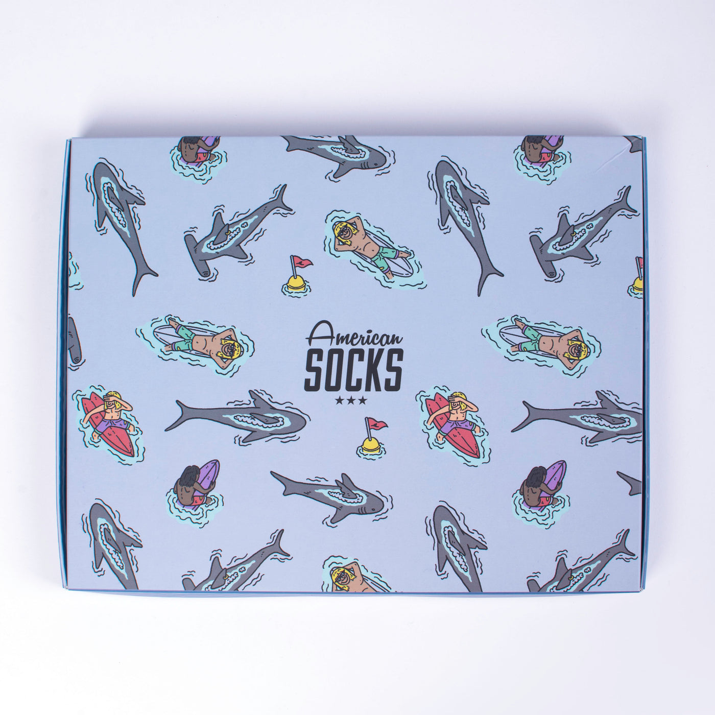 Surfer themed gift box multipack showing sharks and surfers by american socks on a white background